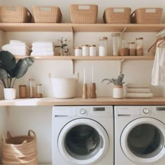 a washer and dryer sitting next to each other on top of a wooden shelf