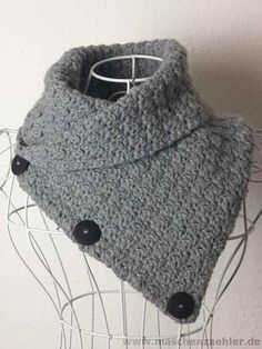 a gray knitted cowl with black buttons