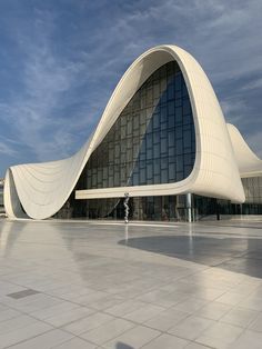 a large building with a curved design on the outside