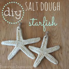 two white starfish ornaments sitting on top of a wooden table