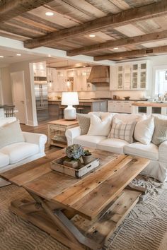 a living room filled with white furniture and lots of wood flooring on the walls