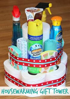 a close up of a cake with toilet paper and other items on it in front of the words housewarming gift tower