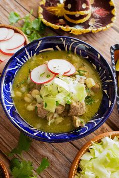 two bowls filled with soup on top of a wooden table next to sliced radishes