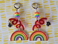 two pairs of earrings with rainbows on them