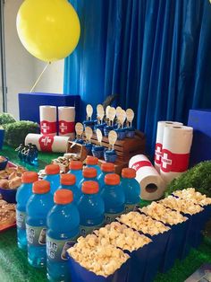 a table filled with lots of food and drinks on top of green carpeted flooring