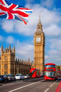 the big ben clock tower towering over the city of london with cars driving down the street