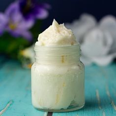 a jar filled with whipped cream sitting on top of a blue table