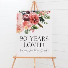 a sign that says 90 years loved happy birthday card on an easel against a white wall