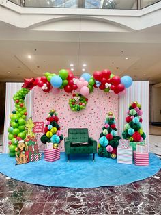 a decorated stage with balloons and presents