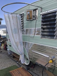 an rv parked on the side of the road with curtains pulled up to it's sides