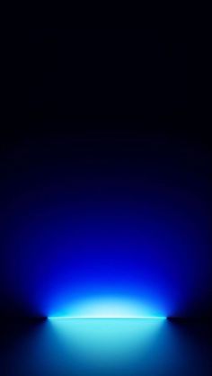 a blue and black background with light coming from the top to the bottom of it