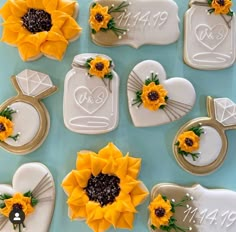 sunflowers and other decorations are arranged on cookie molds in the shape of hearts