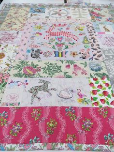 a quilted table top with many different designs on it