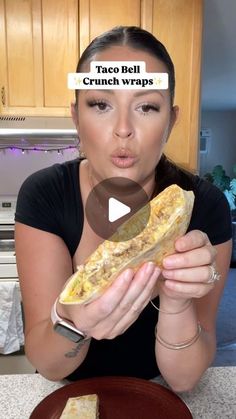 a woman holding a sandwich in her hand and making a face with the caption tag belt crunch wraps