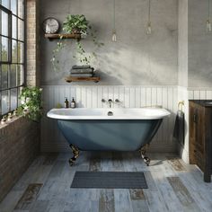 a bath tub sitting next to a window in a bathroom