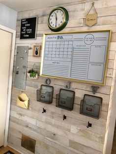 a wall with several mail boxes on it and a clock mounted to the wall above them