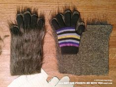 two gloves and one mitt are laying on the floor next to an animal's fur