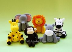 a group of small toy animals sitting next to each other on a green table top