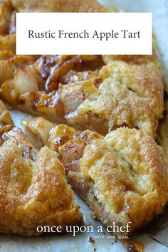 an apple tart is cut into pieces on a piece of parchment paper with the words rustic french apple tart above it