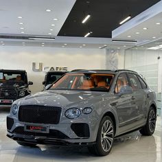 a grey suv is parked in a showroom