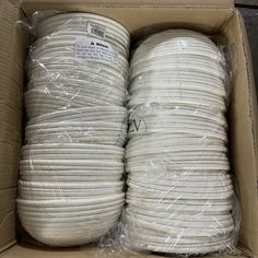 two large white wires in a cardboard box