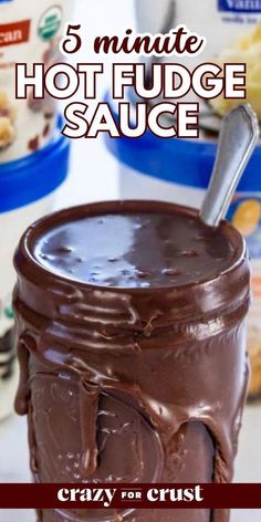 a jar filled with hot fudge sauce on top of a counter