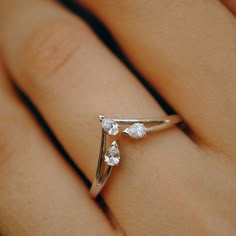 a woman's hand with a diamond ring on top of her finger, showing the band