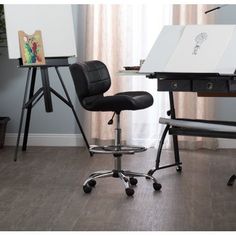 a desk with a chair and easel next to it on top of a hard wood floor