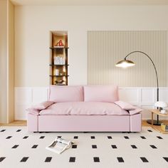 a pink couch sitting on top of a white floor