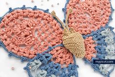 two crocheted doily with a butterfly on top of it and beading around the edges