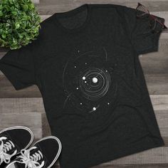 Our Place Among the Stars | Celestial Orbit T-Shirt, Astronomy Graphic Tee, Minimalist Space Art, Space Lover Gift, Unisex Tee, Ulta Soft  This high quality regular fit tee has a casually elegant vibe. Additionally, unbelievably soft tri-blend fabric makes it extremely comfortable - once put on, impossible to take off. SIZING & FABRIC .: 50% polyester, 25% combed ringspun cotton, 25% rayon .: Light Fabric (4.3 oz/yd² (146 g/m .: Regular fit .: Sewn-in label CARE INSTRUCTIONS .: Machine wash: warm (max 40C or 105F) .: Tumble dry: low heat .: Do not iron directly on print .: Do not dry clean PRODUCTION TIME / SHIPPING TIME *Please click the "Shipping and Policies" tab under each listing photo to view our current production time. We strive to respond to your questions within 24-48 hours. Than Space Lovers Gifts, Minimalist Space, Space Lovers, Our Place, Art Space, Space Art, Sew-in Labels, Workout Tee, Astronomy