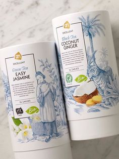 two tubes of coconut tea sitting on top of a marble counter next to each other