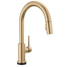 the kitchen faucet is shown in gold, and has an angled spout