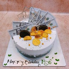 a birthday cake decorated with money and cookies