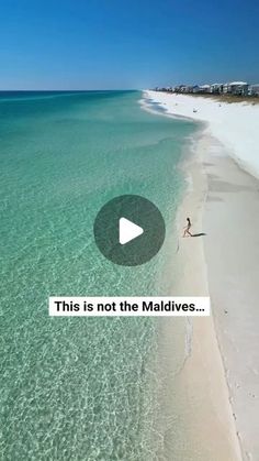 an aerial view of a beach with clear blue water