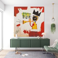 a living room with a painting on the wall and a green chair in front of it