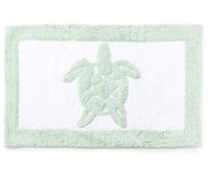 a green and white towel with a sea turtle on the front is shown in this image