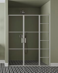 an empty bathroom with green walls and black and white flooring, shower head in the corner