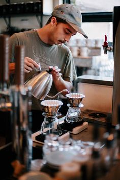 a man pours coffee into a cup