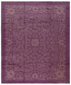 a purple rug with an intricate design on the center and bottom, is shown in full view