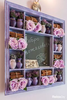 a chalkboard with flowers and cinnamons in it is hanging on the wall next to a candle holder