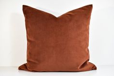 a brown pillow sitting on top of a white table