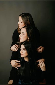 three women are hugging each other and one is holding her arms around the other's shoulders