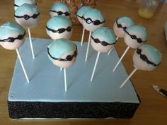 cake pops with blue frosting and black eyeballs on them sitting on a table