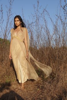 The Jala dress is a modern take on a Grecian inspired romantic feminine style. A beautifully light transparent silk dress that you can get creative layering with your favourite pieces. One Size| AUS 6 - 12 UK 6 - 12 US 2 - 8 EU 34 - 40 Fit | Will drape more on thinner frame Will drape less on fuller frame Paired with | Champagne Rose Slip Note| This fabric varies in shade when in different lights. Dress is transparent. Slip dress is sold separately Care | Please see care label for item specific Silk Sleeveless Dress With Sheer Dupatta, Sleeveless Silk Dress With Sheer Dupatta, Bohemian Dress With Sheer Dupatta And Cape Sleeves, Spring Wedding Gold Gown, Summer Flowy Gown For Wedding Guest, Flowy Summer Gown For Wedding Guest, Summer Wedding Chiffon Dress With Sheer Sleeves, Sheer Flowy Bohemian Maxi Dress, Flowy Sheer Bohemian Maxi Dress