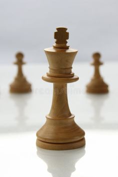 a wooden chess piece is shown in front of other pieces on the table royalty images