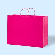 a bright pink shopping bag on a light blue background, with two handles in the middle