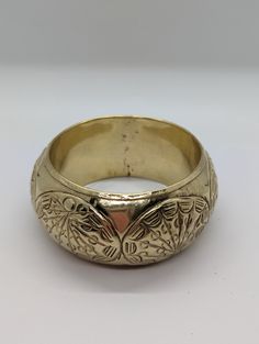 Beautiful! Vintage handmade brass  bangle bracelet. Fancy embossed design. Brass is bright, has been polished.  Some patina on the inside. Measurements : Outer diameter is 8.3 cm,  inner diameter is 6.5cm and  bracelet width is 3.7cm Very good vintage condition. Weighs 59g Festive Round Brass Bracelets, Engraved Metal Bangle For Festivals, Gold Bohemian Etched Cuff Bracelet, Bohemian Gold Etched Cuff Bracelet, Etched Brass Bangle Bracelets, Etched Brass Bangle Bracelet, Traditional Engraved Brass Bangle, Ornate Brass Bangle Bracelet, Etched Metal Bracelet Bangle