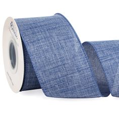 a roll of blue linen ribbon on a white background