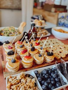 a table topped with lots of food and desserts